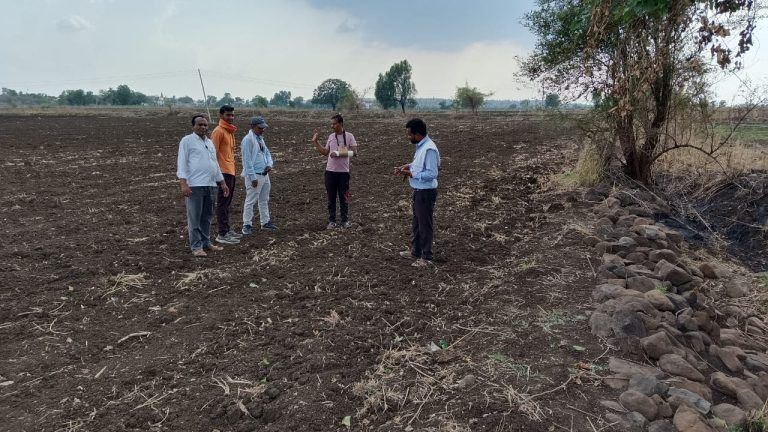 Ground staff inspecting a rocky area for water conservation